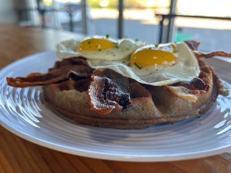 Blue Corn Waffle with eggs at Juniper Coffee and Eatery