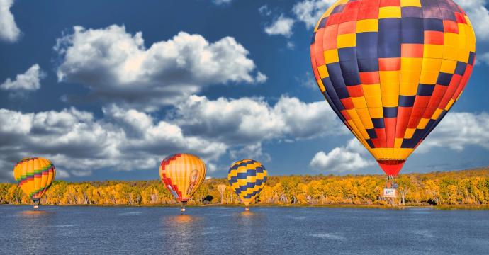 Hot air balloons fly over lake in Farmington New Mexico