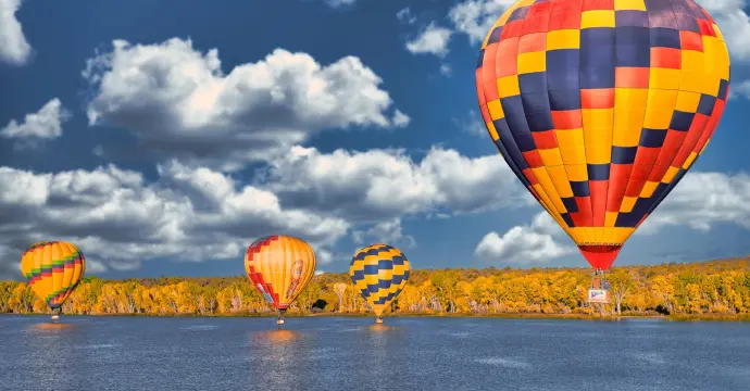 Hot air balloons fly over lake in Farmington New Mexico
