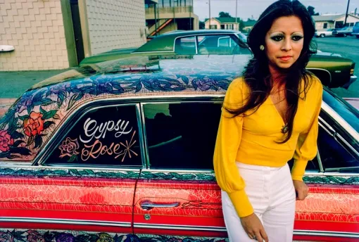 Photo of woman and Gypsy Rose Lowrider featured in the Lowrider Culture in the United States traveling exhibit